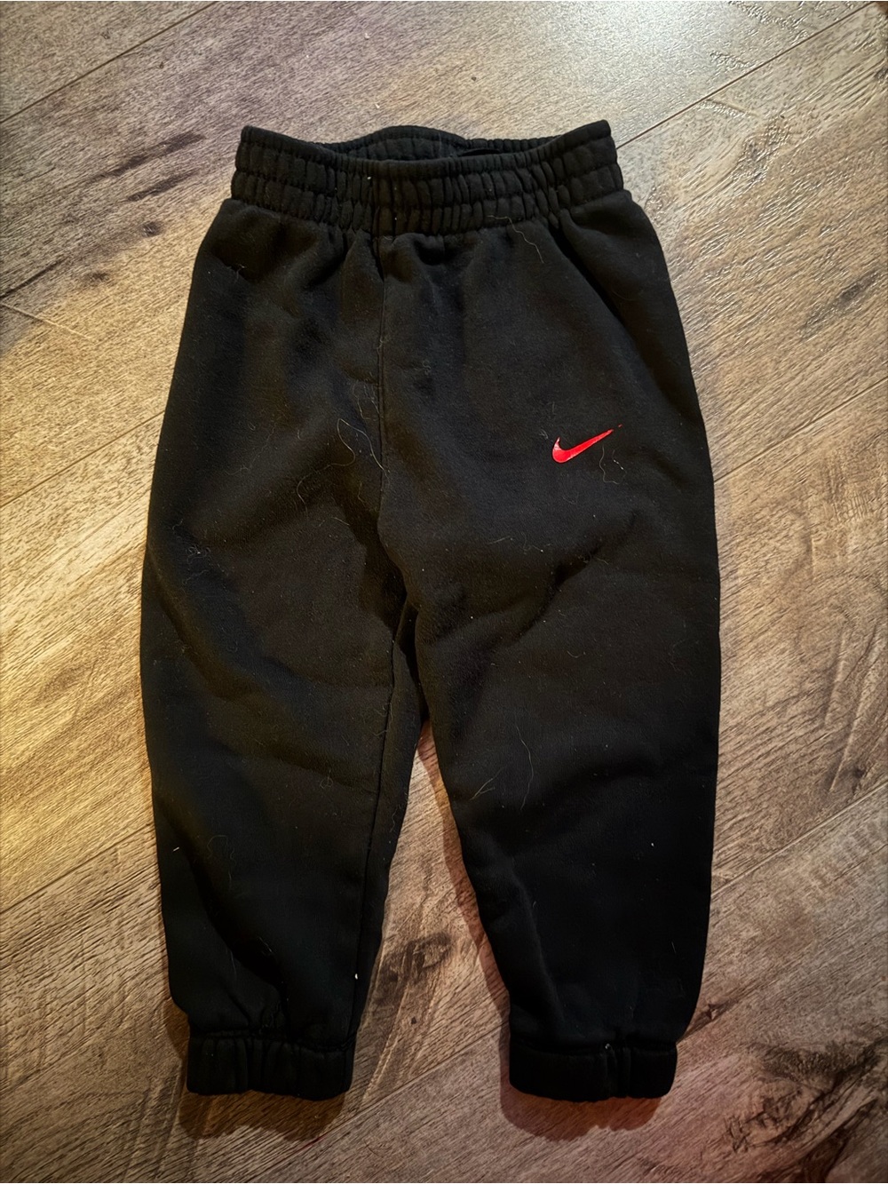 Nike Kids Black Sweatpants with Red Swoosh Logo